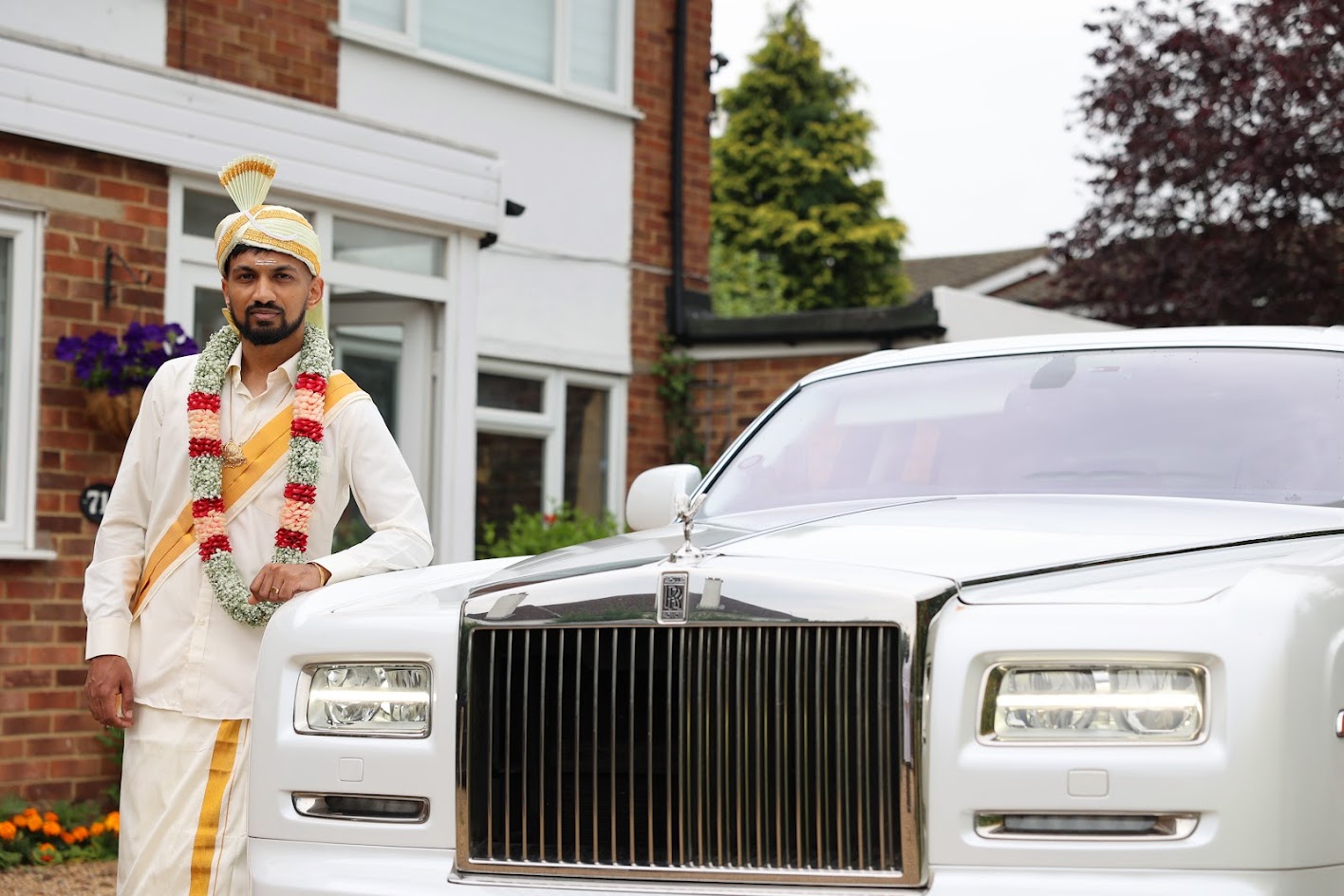 Tamil Groom in wedding outfit next to Rolls Royce